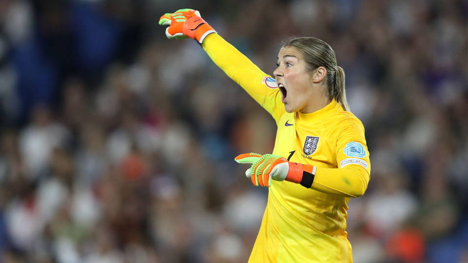 Mary Earps pointing, wearing a yellow football kit